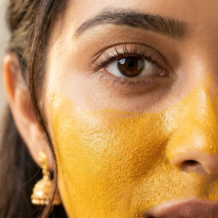Haldi ubtan on the cheek