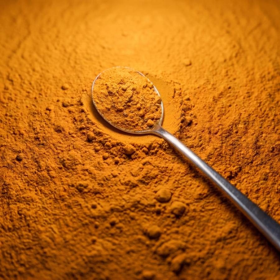 Steel spoon in Lakadong turmeric